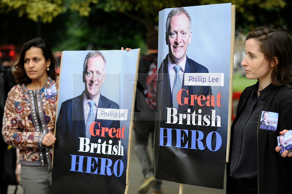 © Licensed to London News Pictures. 12/06/2018. LONDON, UK. Anti-Brexit protesters hold up posters of Phillip Lee outside the Houses of Parliament as MPs begin two days of debate to vote on amendments to the EU Withdrawal Bill. Justice Minister Phillip Lee resigned today in protest about the economic impact of Brexit. Photo credit: Stephen Chung/LNP