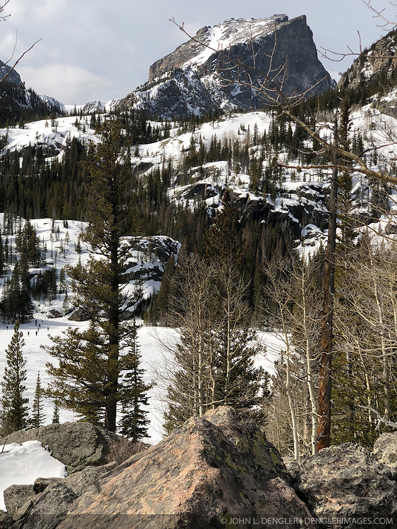 Hallett Peak (12,720 feet) looms above a frozen Bear Lake in Rocky Mountain National Park in March.