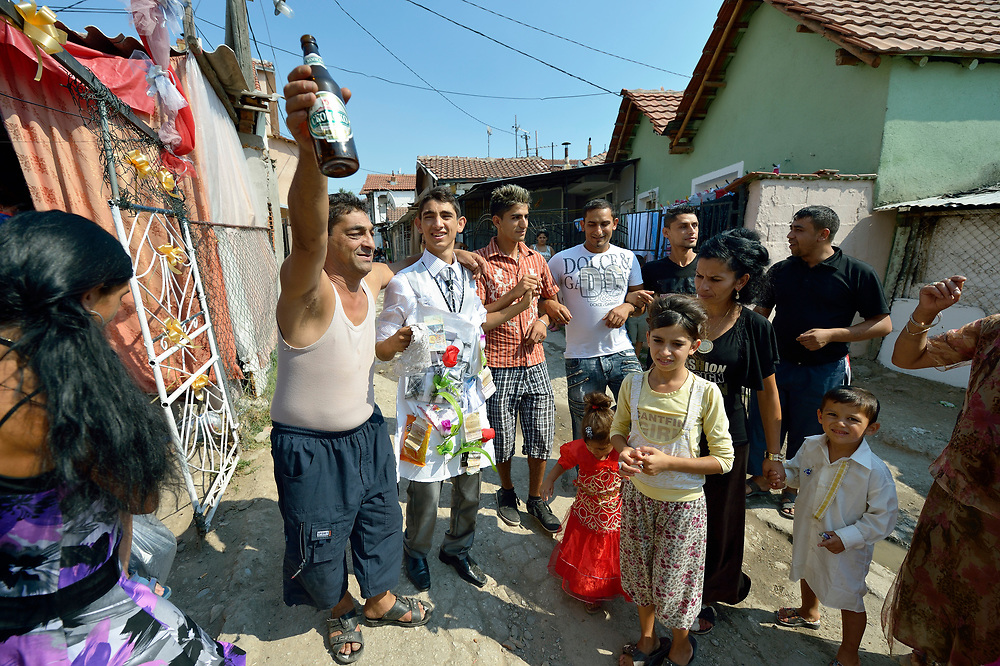 The groom's father toasts his son and his new wife during a wedding in Suto Orizari, Macedonia. The mostly Roma community, located just outside Skopje, is considered Europe's largest Roma settlement. .