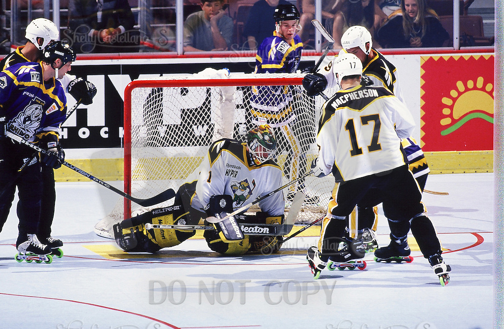 1999: Roller hockey goaltender Rob Laurie makes a save for the Anaheim Bullfrogs at the Pond. Transparency image scan.