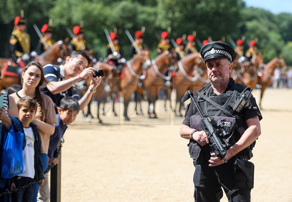 © Licensed to London News Pictures. 16/07/2016. London, UK. Armed police watch over a parade on Horseguards Parade in Westminster, London two days after more than 80 people were killed in a terrorist attack in Nice, southern France. Photo credit: Ben Cawthra/LNP