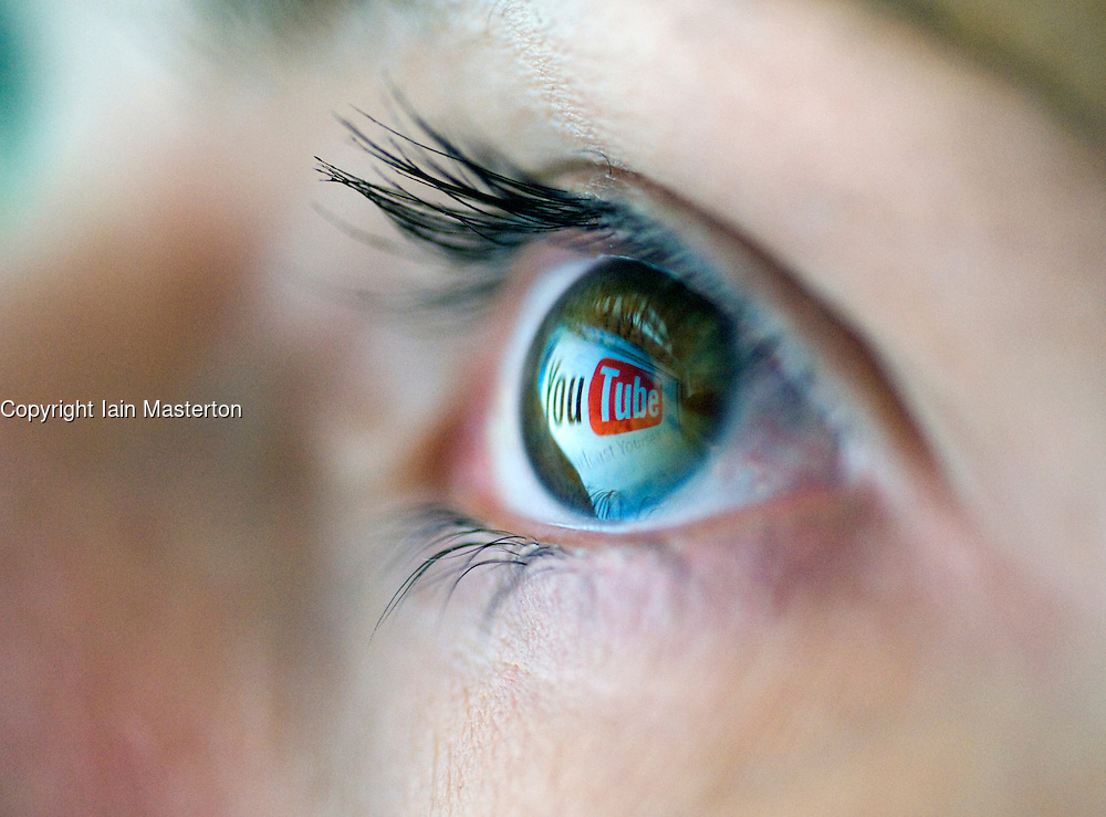 Logo from Video file sharing website YouTube is reflected from computer creen onto womans eye 2008