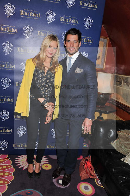 Left to right, LAURA WHITMORE and DAVID GANDY at the Johnnie Walker Blue Label and David Gandy partnership launch party held at Annabel's, 44 Berkeley Square, London on 5th February 2013.