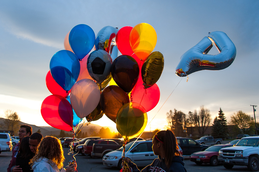 On May 2, 2014, students and friends of slain German exchange student, Diren Dede, carry balloons on to the soccer field at Fort Missoula where Dede played soccer. Dede wore jersey #4 when playing soccer.