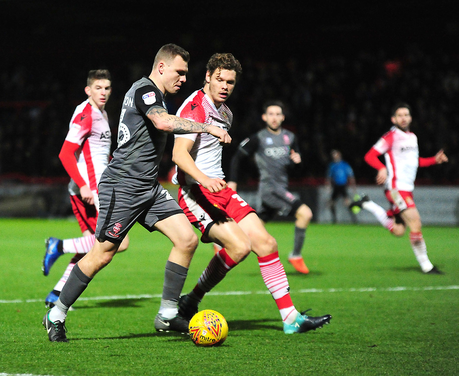 Lincoln City's Harry Anderson crosses under pressure from Stevenage's Ben Nugent<br />
<br />
Photographer Andrew Vaughan/CameraSport<br />
<br />
The EFL Sky Bet League Two - Stevenage v Lincoln City - Saturday 8th December 2018 - The Lamex Stadium - Stevenage<br />
<br />
World Copyright © 2018 CameraSport. All rights reserved. 43 Linden Ave. Countesthorpe. Leicester. England. LE8 5PG - Tel: +44 (0) 116 277 4147 - admin@camerasport.com - www.camerasport.com